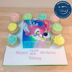 a birthday cake decorated with cupcakes and frosting