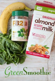 an image of green smoothie with almonds and banana on the table next to it