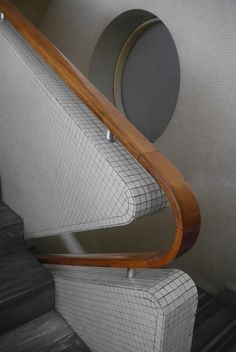 an escalator with wooden handrails and tiled walls