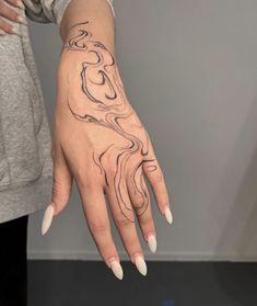 a woman's hand with a tattoo on it