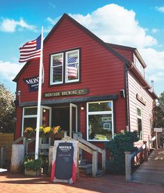 a red building with an american flag in the window and sign for mountain brewing co