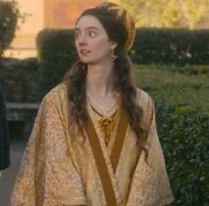 the young woman is dressed in medieval clothing