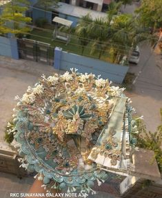 an overhead view of a clock tower with many decorations on it's face and hands