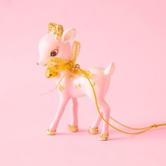 A small pink deer with gold glitter spots and feet stands on a pink ground.  The deer has a big gold bow around it's neck and a gold jingle bell. Pink Deer Ornament, Vintage Pink Christmas, Pink Deer, Kitsch Christmas, Pink Xmas, Deer Ornament, Pink Ornament, Sweets Gift, Notes Gift