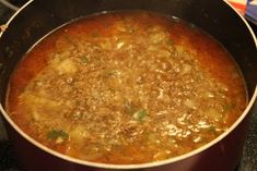 a pot filled with meat and vegetables on top of a stove