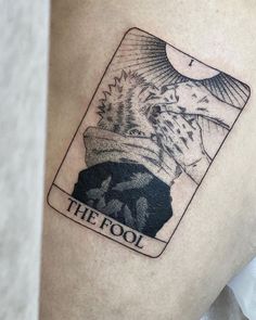 the fool tarot card tattoo on the thigh