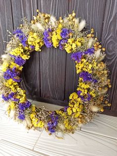 a wreath with yellow and purple flowers on it