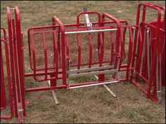 two red metal gates are in the grass