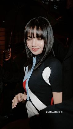 a woman in black and white dress holding an umbrella