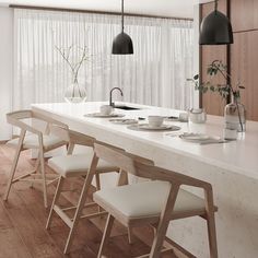 a long table with white chairs and plates on it in front of a curtained window