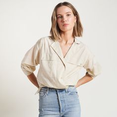 The Fay Boyfriend Shirt is roomy and relaxed but decidedly feminine and sophisticated. Crafted from cotton lawn, a lightweight yet durable fine thread poplin, the Faye has a silky-smooth hand feel. Its unique features include a lay-flat camp collar with an elevated top button and loop closure, wide-set pleated center front placket, and exquisite topstitching details on the sleeve placket and cuff. 100% Cotton Button flap patch pockets at the chest High side-slits at the hem for a fashionable tuc Relaxed Fit Blouse With Placket For Spring, Spring Relaxed Fit Blouse With Placket, Spring Shirt With Lapel Collar And Relaxed Fit, Spring Lapel Collar Shirt With Relaxed Fit, Relaxed Fit Shirt With Lapel Collar For Day Out, Camp Collar Shirt With Pockets For Daywear, Beige Relaxed Blouse For Spring, Relaxed Fit Blouse With Roll-up Sleeves For Day Out, Spring Blouse With Spread Collar For Day Out