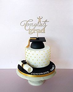 a graduation cake with the words congrats grad on top and a mortar cap atop it