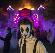 a man dressed up as a mime in front of a building with lights on it