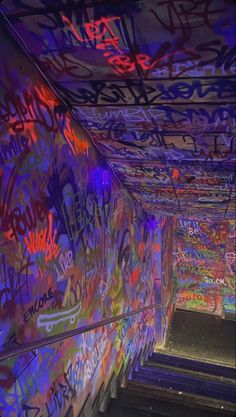 the walls are covered in graffiti and have been lit up by colorful lights on them