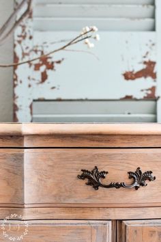 an old wooden dresser with peeling paint on it