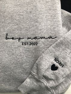 two gray sweatshirts with the words baby mama est 2020 printed on them, next to each other