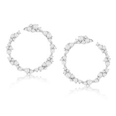 Add the perfect amount of sparkle to your ears with these white cubic zirconia open circle cluster earrings. These beautiful earrings features prong set white round cut cubic zirconia in an unique cluster floral design. When wearing these earrings, they will hang on your ears and will create shimmer and shine from every angle. These earrings are hand set in 925 sterling silver with a high polish finish. Surprise someone special in your life with these luxurious earrings. The perfect gift that is Luxurious Earrings, Gemstone Brooch, Cubic Zirconia Bracelet, Luxury Earrings, Cubic Zirconia Necklace, Shimmer And Shine, Cubic Zirconia Jewelry, Jewelry Rings Diamond, Cubic Zirconia Earrings