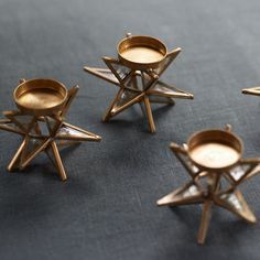 four brass candlesticks sitting on top of a table