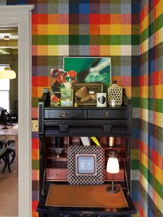 a room with colorful wallpaper and furniture in it