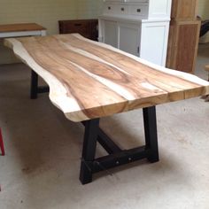 a large wooden table sitting inside of a room