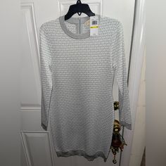 I’m Selling My Micheal Kors Sweater Dress In A Medium (It Fits As A M/L). Brand New With Tags And Plastic. Never Worn. Silver Mk Jacquard Logo Across Entire Dress Silver Long Sleeve Spring Dress, Silver Long Sleeve Dresses For Spring, Michael Kors Dresses, Sweater Dress, Michael Kors, Brand New, Womens Dresses, Tags, Silver