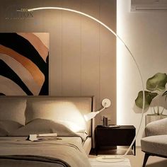 a bedroom with a bed, chair and art work on the wall behind it is lit by a floor lamp