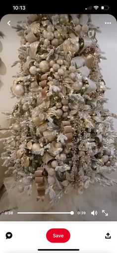 the christmas tree is decorated with white and gold ornaments