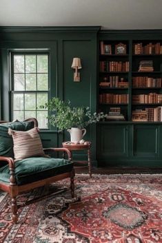 a living room with green walls and lots of books on the bookcases in it