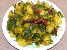 a white plate topped with vegetables on top of a table