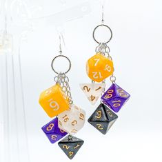 two pairs of dice earrings with numbers on them