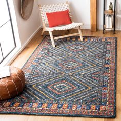 a room with a chair and rug on the floor