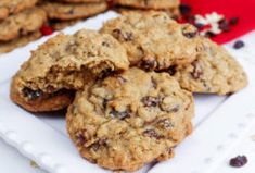 chocolate chip cookies on a white plate next to other cookies