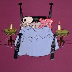 the skeleton is laying in bed with candles