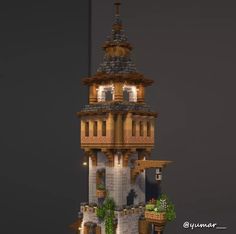 a very tall tower with a clock on it's side and plants growing out of the top