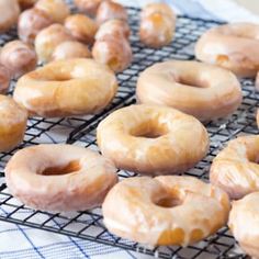 a bunch of doughnuts that are on a cooling rack