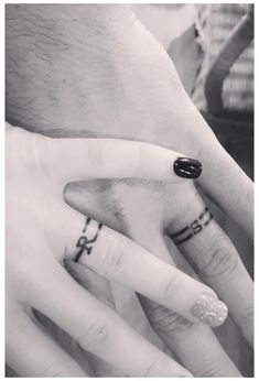 two people with wedding rings on their fingers