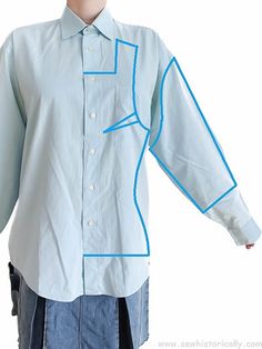 a mannequin wearing a shirt with blue trimmings and buttons on it