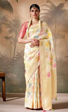 Indulge in the timeless charm of this exquisite Muga Silk Paithani Banarasi Saree, skillfully woven with intricate Resham floral motifs and enhanced by luxurious tassels. The rich Zari work throughout the saree adds a touch of regal elegance, making it perfect for weddings, festive occasions, or cultural celebrations. With its light, breathable Munga Silk fabric, this saree not only radiates sophistication but also ensures comfort for all-day wear, combining traditional artistry with modern grace. --------------------------------- S A R E E ● D E T A I L S --------------------------------- ● Fall and Edging : Done ● Tassel : See in Option ● Petticoat : On request Extra Charges ● Drapping Saree (Ready to wear) : On Request Extra Charges ● Blouse : Matching Unstitched Piece (See in option) ● Munga Silk Saree, Drapping Saree, Muga Silk, Patiala Salwar, Cultural Celebration, Trendy Sarees, Cream Silk, Zari Work, Banarasi Saree