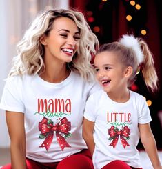 Celebrate the holiday season in style with these Mama Claus and Little Claus Matching Christmas Shirts! Featuring a cheerful red bow with festive holly accents, these shirts are perfect for moms and their little ones to spread holiday joy together. Available in both black and white options and in a range of sizes for adults, kids, and toddlers, this matching set is ideal for Christmas gatherings, family photo sessions, or cozying up by the tree. With a comfy fit and adorable holiday-themed desig Matching Christmas Shirts, Daughter Christmas, Mom And Daughter, Buffalo Plaid Christmas, Family Photo Sessions, Bow Design, Plaid Christmas, Red Bow, Toddler Sizes