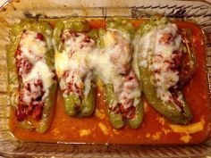 green peppers covered in cheese and sauce on a baking dish with a wire rack underneath