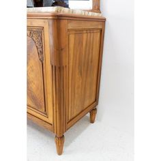 an old wooden cabinet with a mirror on top