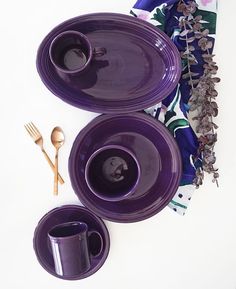 purple plates and cups on a white table