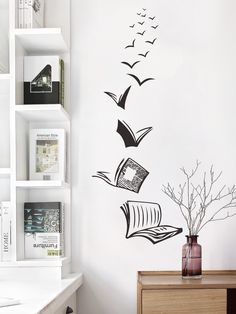 a room with a book and birds flying over the bookshelf wall decal