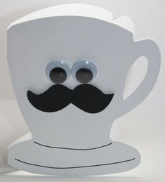 a paper cup with googly eyes and a mustache