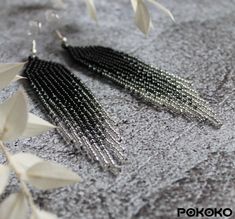 "These black silver beaded earrings pair amazingly with any outfit, dressy or casual. They will emphasize your individuality and compliment your personality on various occasions. Perfect for looking pulled together and on trend. They are made of high-quality Czech colored beads with sterling silver hooks and silicone plugs. Colors: black, silver. Length: 3.6 inches (9.2 cm) Width: 0.78 inches (2 cm) Materials:     Czech \"Preciosa\" beads     Durable synthetic thread     Sterling silver ear hooks     Silicone plugs If you are on the hunt for a gift that will show your significant other some love, these picks are a great solution to surprise and delight. I hope you can find everything here that you were looking for. If you have any questions related to earrings design, please feel free to c Seed Bead Earring, Red Bead Earrings, Silver Bead Earrings, Earring Long, Beadwork Earrings, Bead Earring, Earring Dangle, Grey Beads, Luxury Earrings