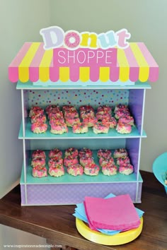 a donut shop display with cupcakes and sprinkles on it