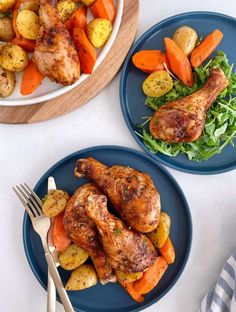 two plates with chicken, potatoes and carrots on them next to a bowl of salad