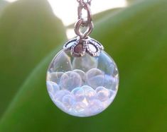 a close up of a glass ball on a chain