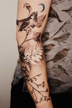 a person with a bird tattoo on their arm and the other arm is full of birds