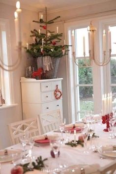 a dining room table set for christmas dinner